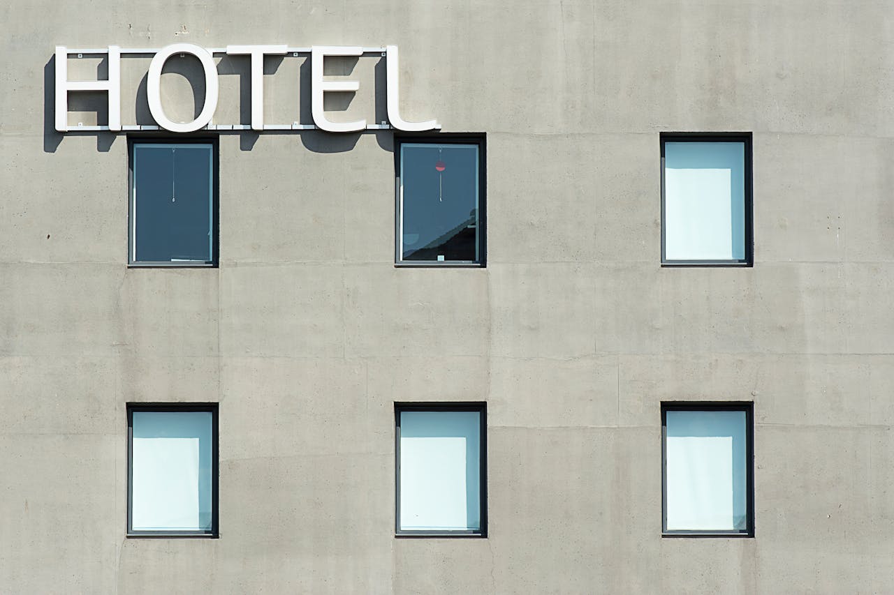 Contemporary hotel facade featuring minimalist design and geometric window patterns.